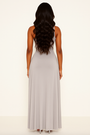 Woman wearing a light gray sleeveless dress on a white background