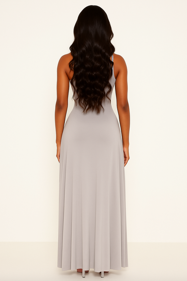 Woman wearing a light gray sleeveless dress on a white background
