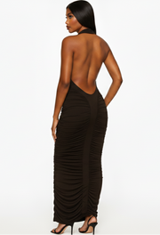 Woman wearing a brown halter neck dress with ruched sides on a white background