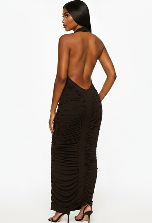 Woman wearing a brown halter neck dress with ruched sides on a white background