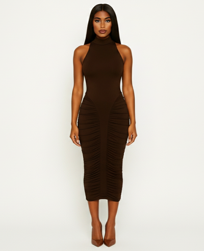 Woman wearing a brown halter neck dress with ruched sides on a white background