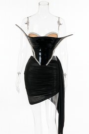 Black dress with sheer overlay on a mannequin against a white background