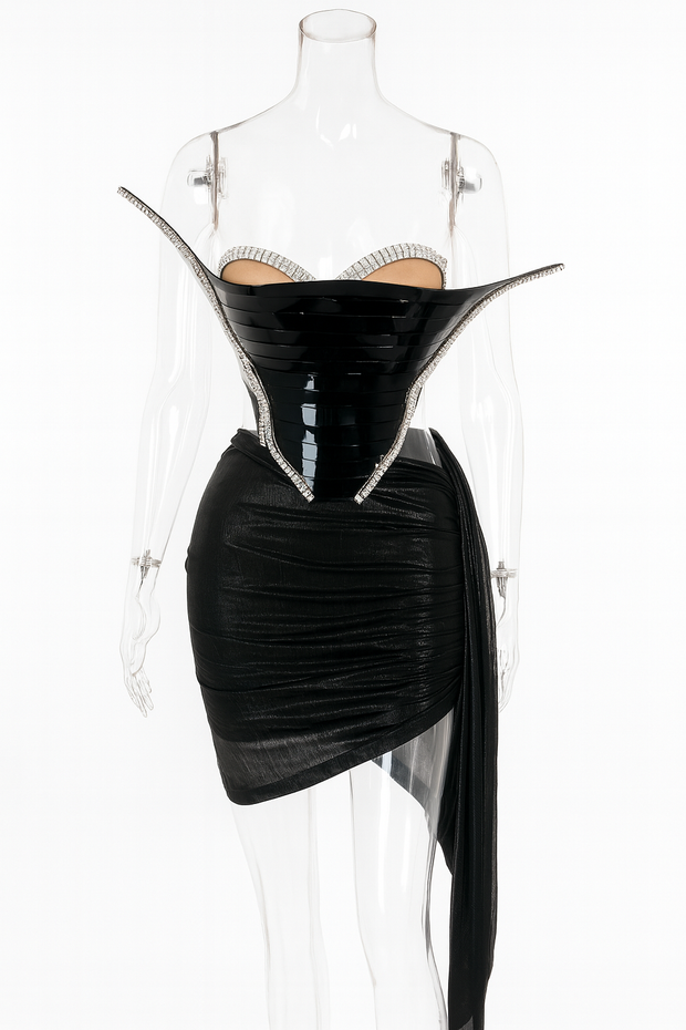Black dress with sheer overlay on a mannequin against a white background