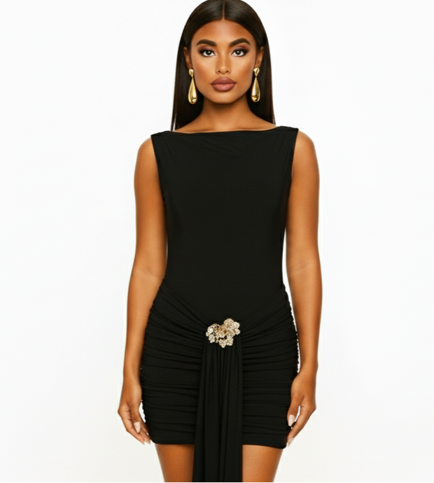Woman wearing a black dress with a decorative brooch on a white background