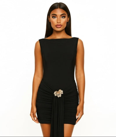 Black dress with a belt worn by a model on a white background