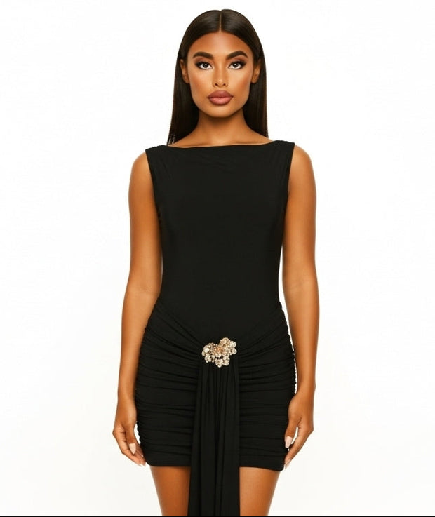 Black dress with a belt worn by a model on a white background