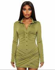 Woman wearing a green ruched dress on a white background