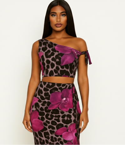 Woman wearing a leopard print and pink floral dress on a white background