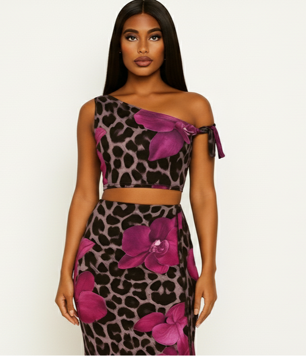 Woman wearing a leopard print and pink floral dress on a white background