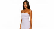 Woman wearing a strapless white dress on a white background