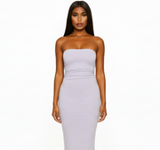 Woman wearing a strapless white dress on a white background