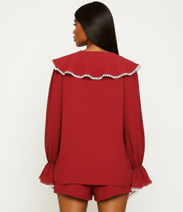 Red outfit with white trim on a plain background