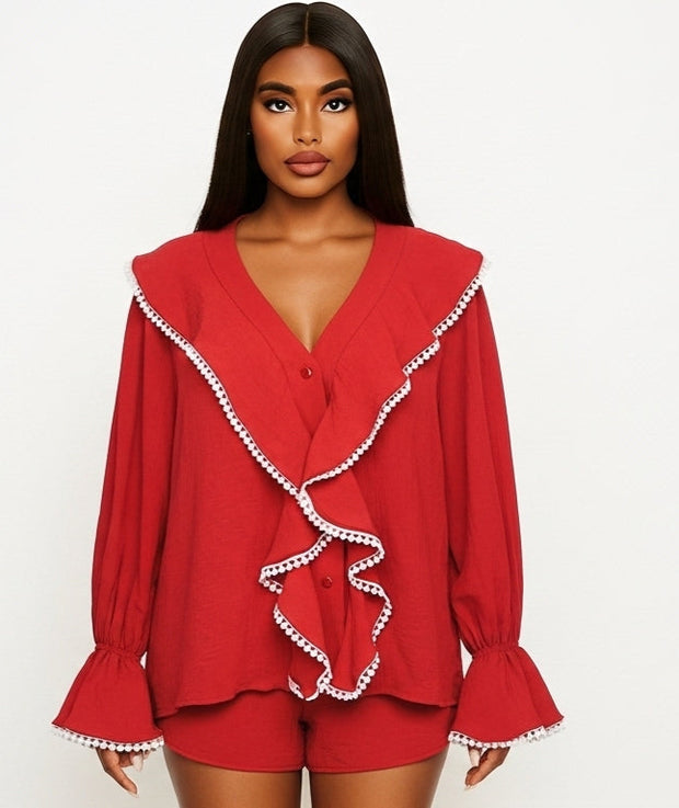 Woman wearing a red outfit with white trim on a white background