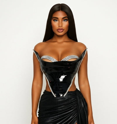 Woman wearing a black outfit with a sheer overlay on a white background