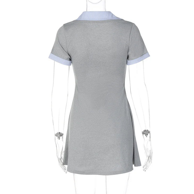 Gray dress with blue trim on a mannequin against a white background
