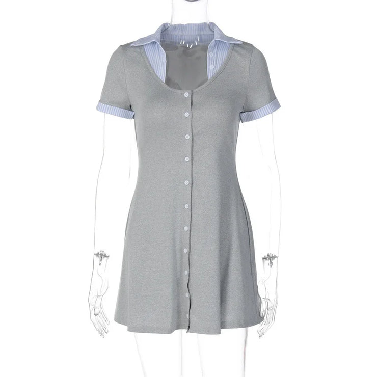 Gray dress with blue trim on a mannequin against a white background