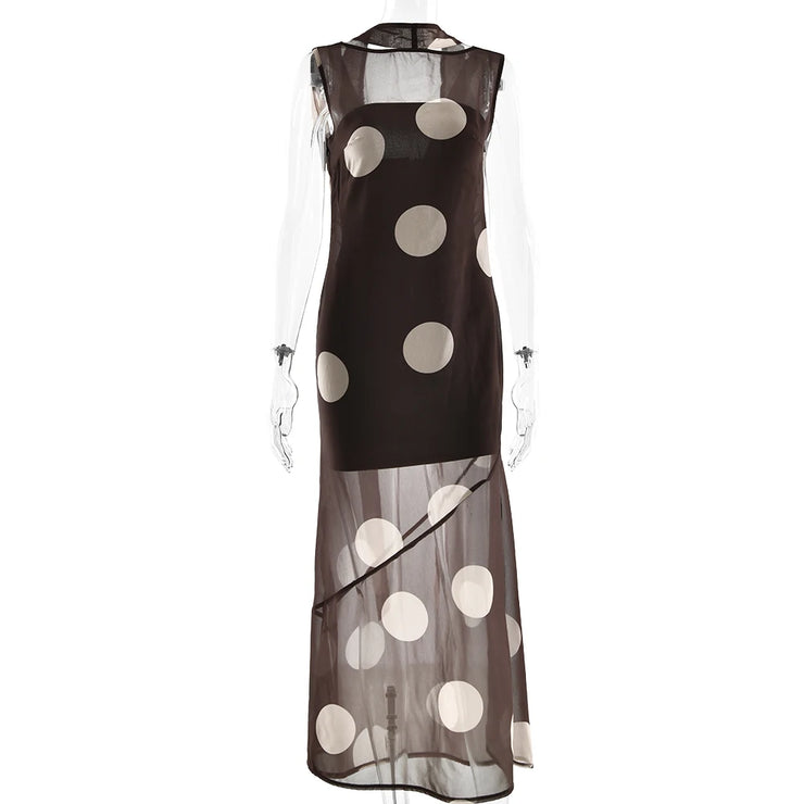 Black dress with white polka dots on a white background