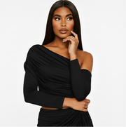 Woman wearing a black one-shoulder dress on a white background
