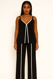 Woman wearing a black and white outfit with a plain background